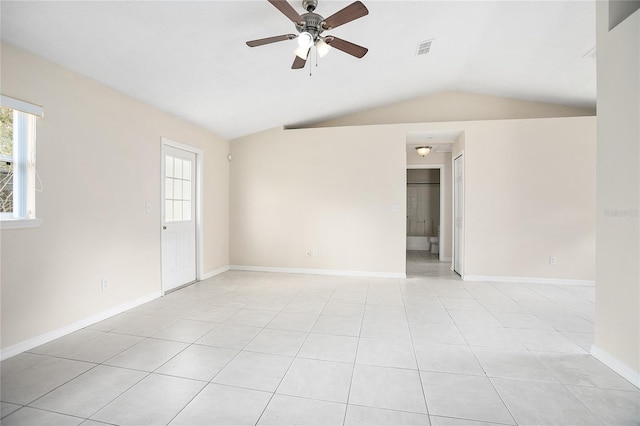 tiled empty room with lofted ceiling and ceiling fan