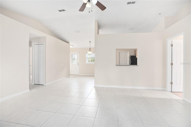 tiled spare room with lofted ceiling and ceiling fan