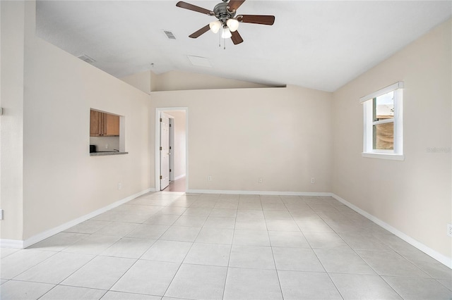 spare room with ceiling fan, light tile floors, and lofted ceiling