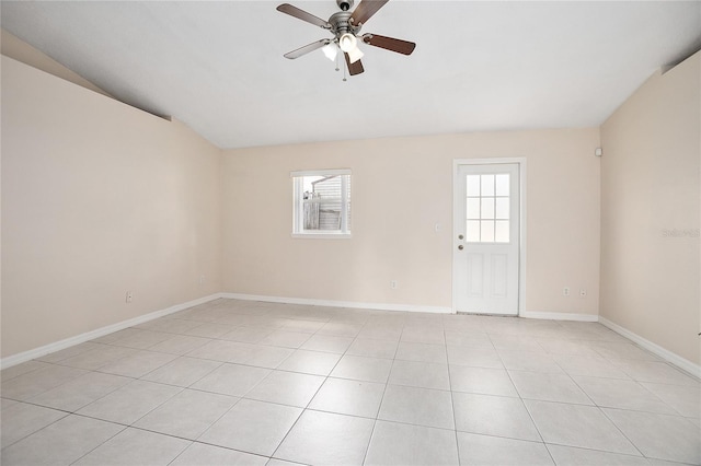 tiled spare room featuring vaulted ceiling and ceiling fan