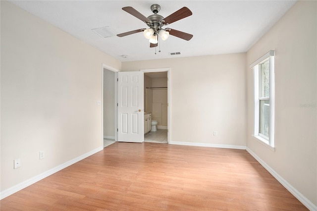 unfurnished bedroom with multiple windows, ceiling fan, and light wood-type flooring