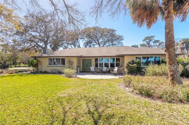 exterior space featuring a front lawn and a patio