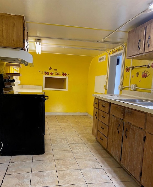 kitchen featuring black electric range, light tile patterned floors, ventilation hood, and sink