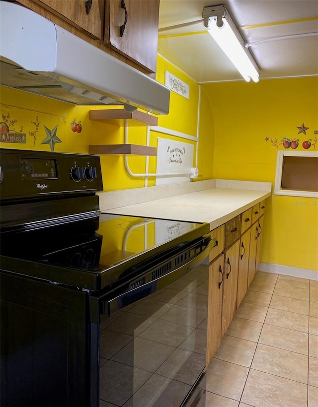 kitchen featuring black electric range oven and light tile patterned floors