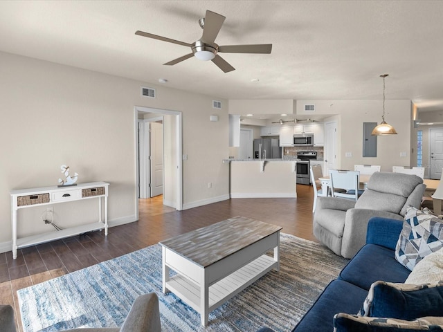 living room featuring ceiling fan and dark wood-type flooring