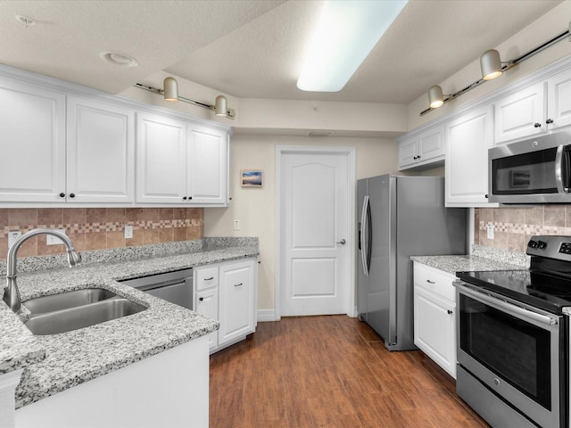 kitchen with white cabinetry, sink, stainless steel appliances, tasteful backsplash, and dark hardwood / wood-style flooring