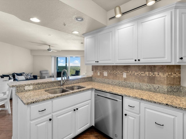 kitchen featuring white cabinets, ceiling fan, sink, and stainless steel dishwasher