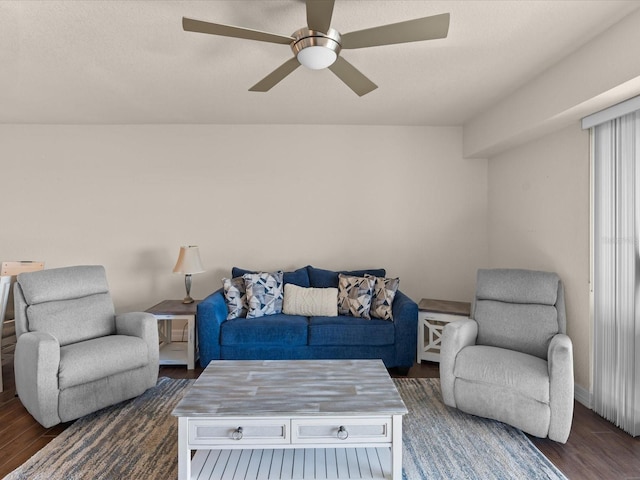 living room featuring ceiling fan and dark hardwood / wood-style flooring