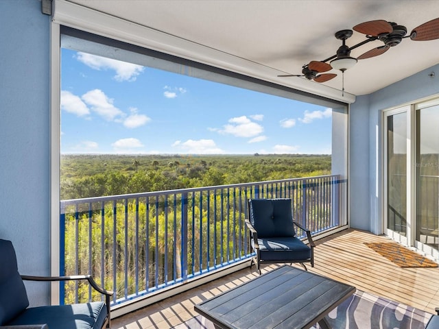 balcony featuring a baseboard radiator and ceiling fan