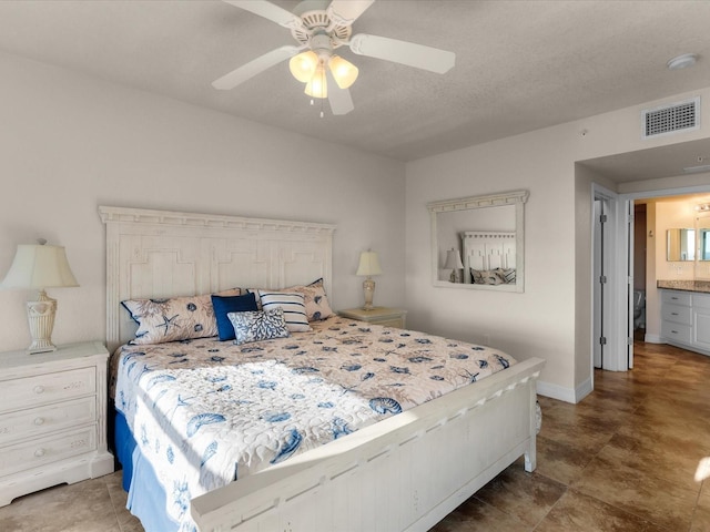 bedroom featuring ensuite bathroom, tile floors, and ceiling fan