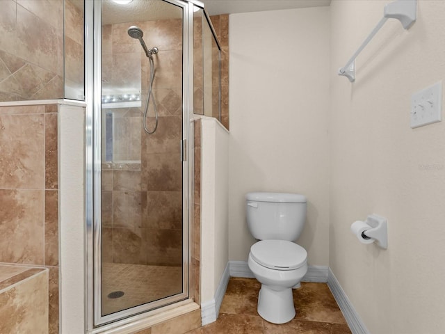 bathroom with toilet, a shower with door, and tile floors