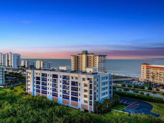 outdoor building at dusk featuring a water view