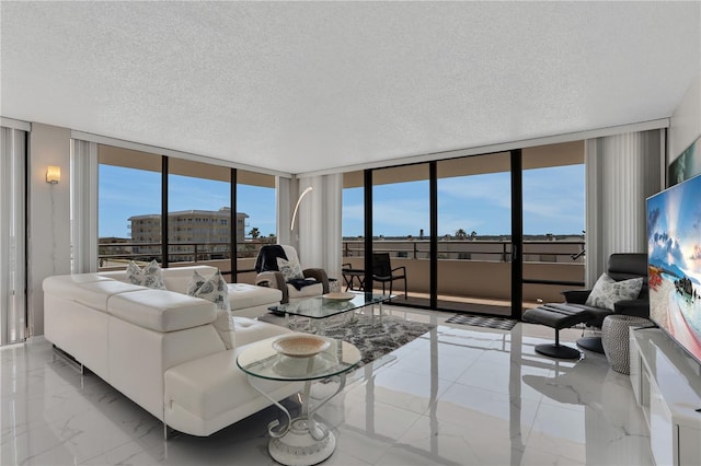 living room featuring expansive windows, light tile floors, and a textured ceiling