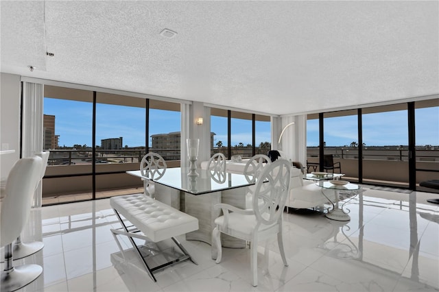 tiled dining space featuring expansive windows and a textured ceiling