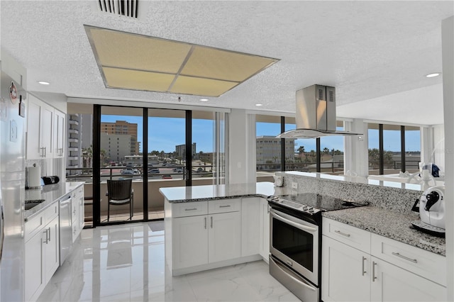 kitchen with light tile floors, electric range, white cabinets, island exhaust hood, and light stone counters