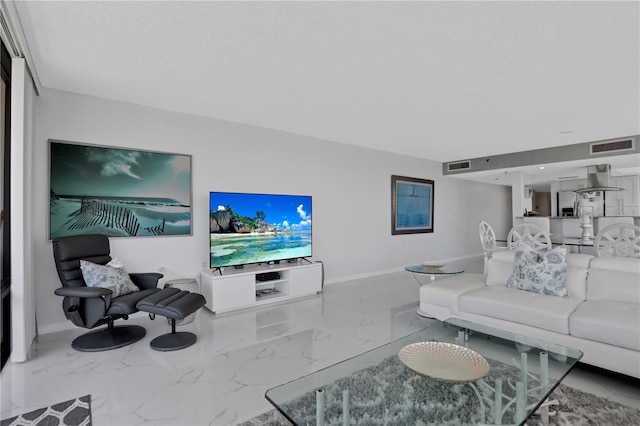 living room with light tile floors and a textured ceiling