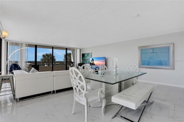 tiled dining area with a textured ceiling