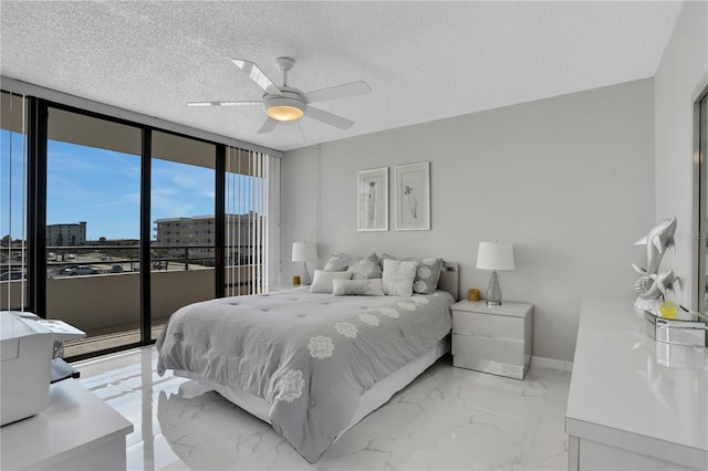 tiled bedroom with a wall of windows, access to outside, ceiling fan, and a textured ceiling