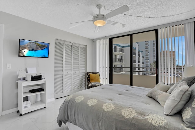 bedroom featuring a closet, a textured ceiling, ceiling fan, and light tile floors