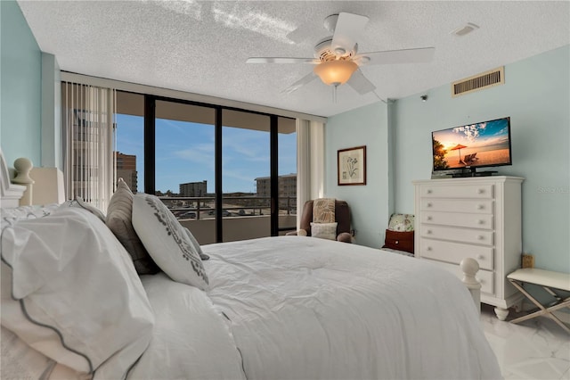 bedroom with ceiling fan, a textured ceiling, floor to ceiling windows, light carpet, and access to outside