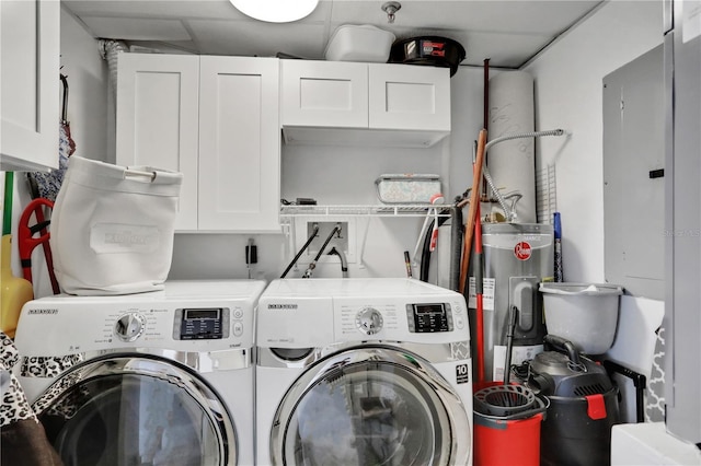 laundry room with separate washer and dryer, water heater, and cabinets