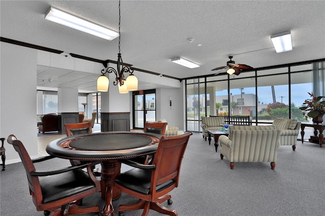 dining area with a textured ceiling, ceiling fan with notable chandelier, and a healthy amount of sunlight