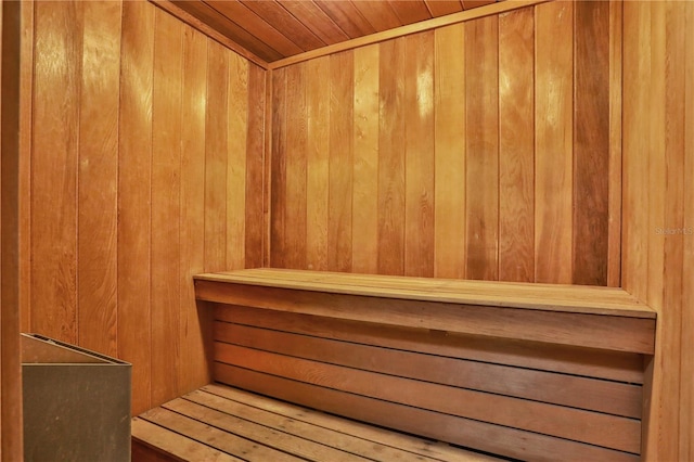 view of sauna / steam room featuring wood ceiling and wooden walls