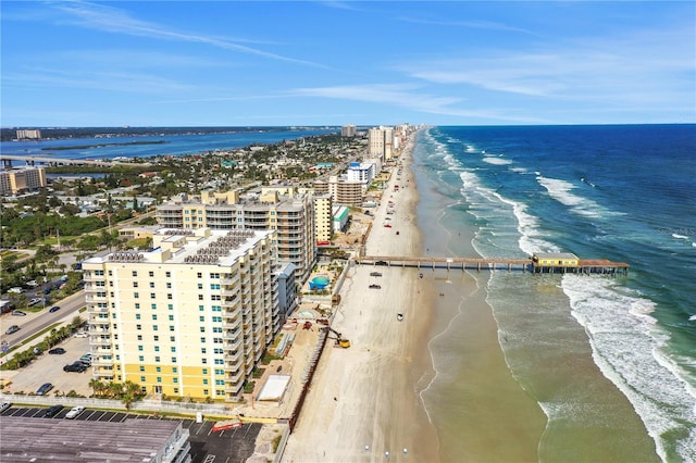 drone / aerial view featuring a water view and a view of the beach