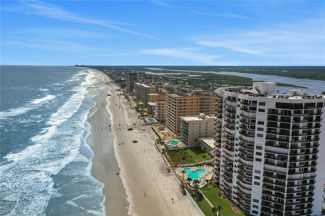 bird's eye view with a water view and a beach view