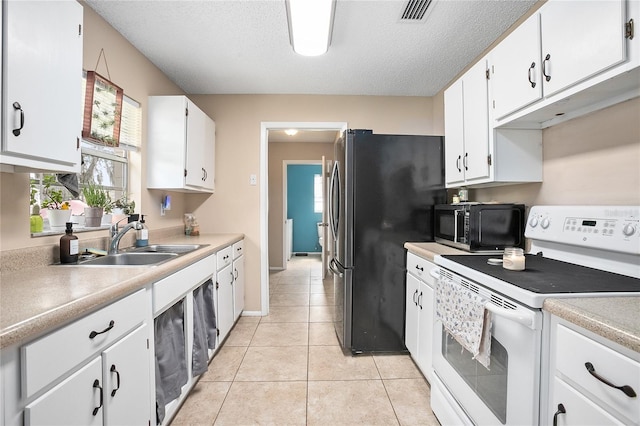 kitchen featuring black appliances, light tile floors, white cabinetry, and sink