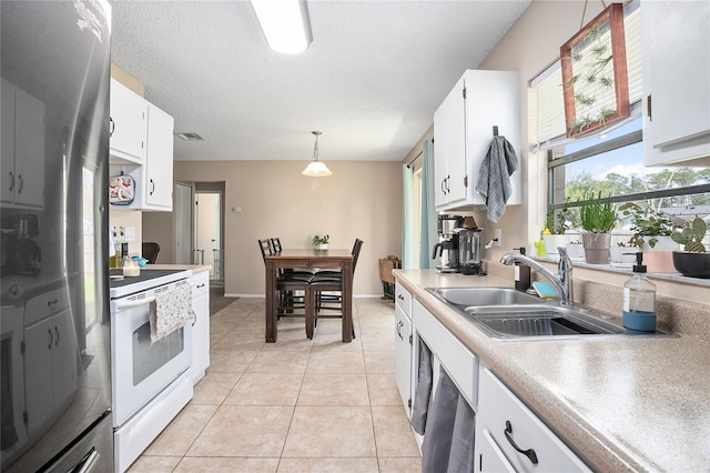 kitchen featuring light tile floors, white cabinetry, white electric range, and pendant lighting