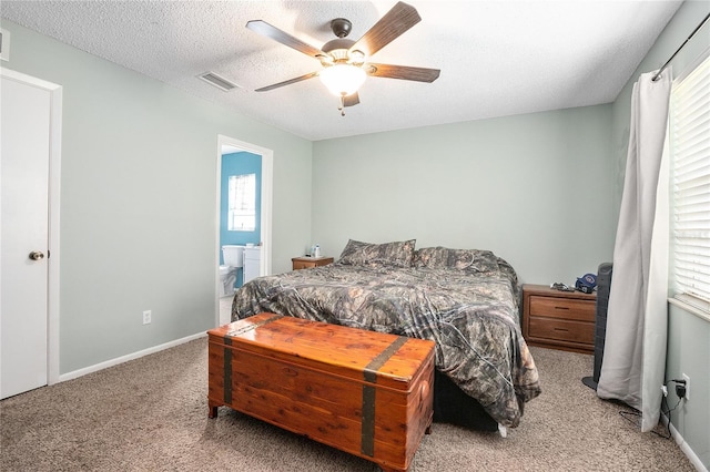 carpeted bedroom featuring ensuite bathroom, ceiling fan, and a textured ceiling