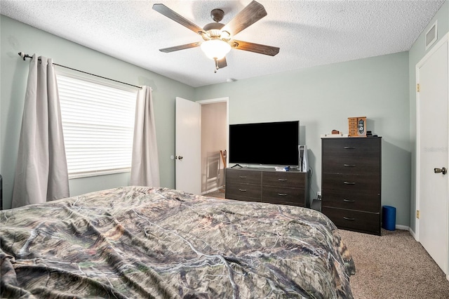 bedroom with light carpet, a textured ceiling, and ceiling fan