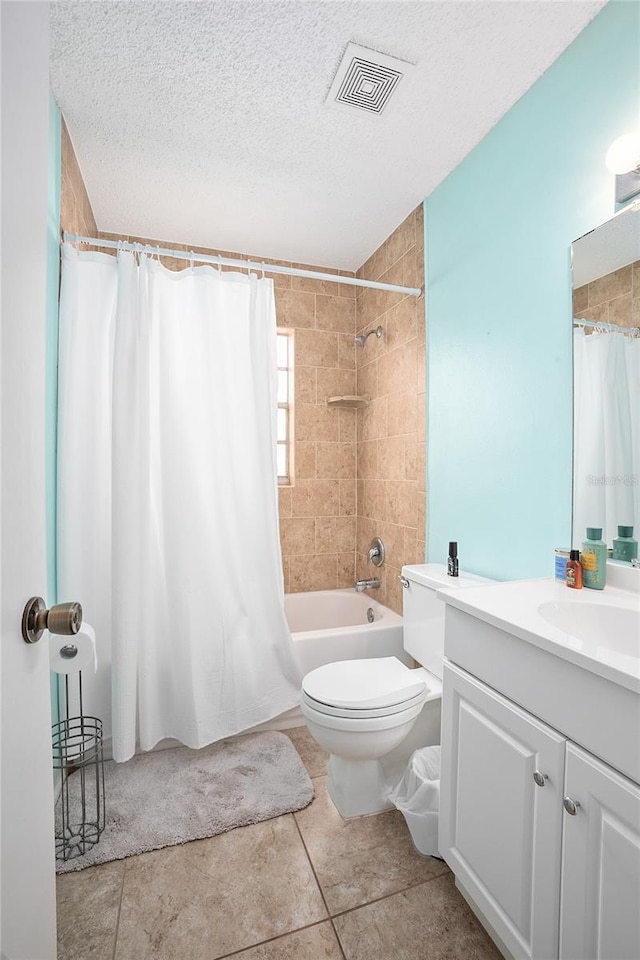 full bathroom with toilet, vanity with extensive cabinet space, shower / bath combo with shower curtain, tile floors, and a textured ceiling