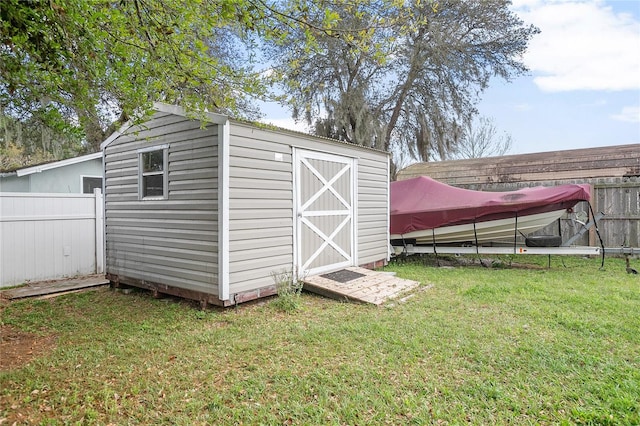 view of shed / structure with a lawn