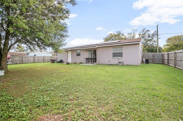 back of property featuring a patio area, central air condition unit, and a yard