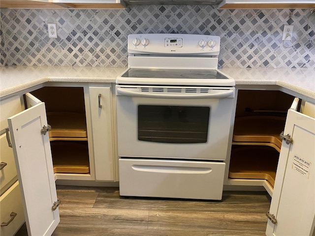 kitchen with white range with electric cooktop, tasteful backsplash, and dark wood-type flooring