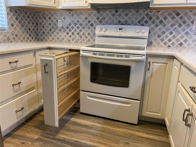 kitchen with white electric range oven, tasteful backsplash, and dark wood-type flooring