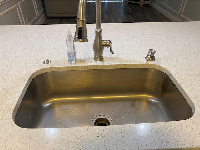 details featuring dark hardwood / wood-style flooring and sink