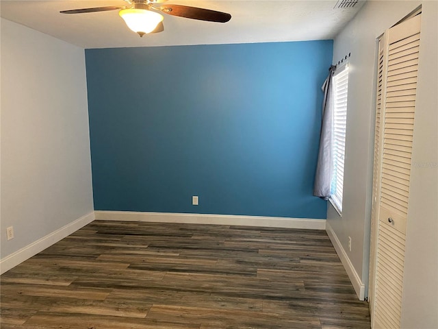 unfurnished room with ceiling fan and dark hardwood / wood-style flooring