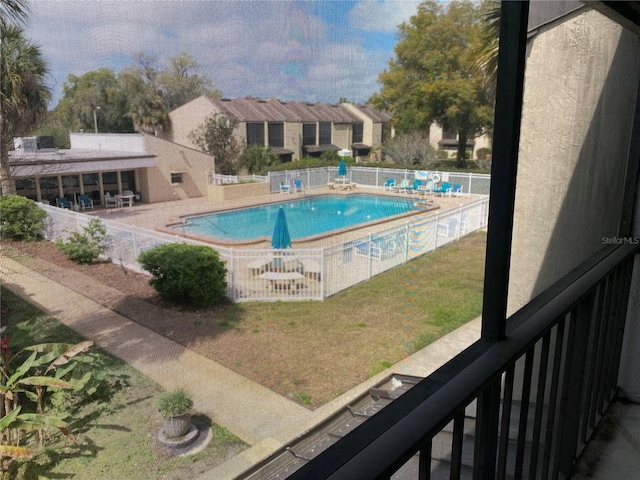 view of swimming pool with a yard and a patio