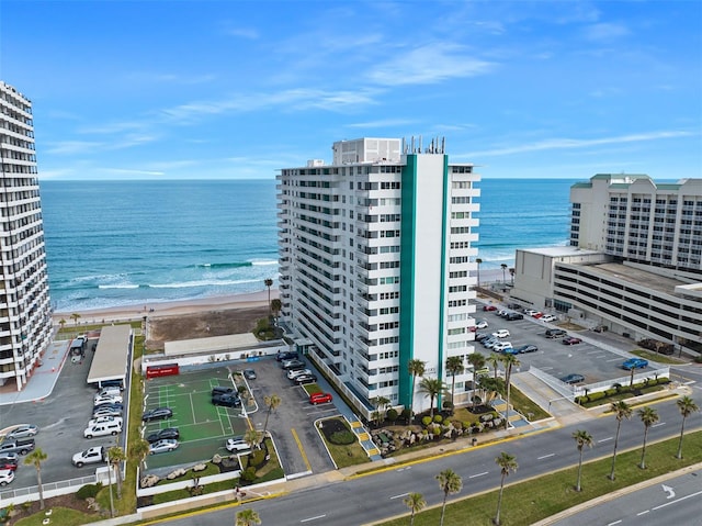 drone / aerial view with a water view and a beach view