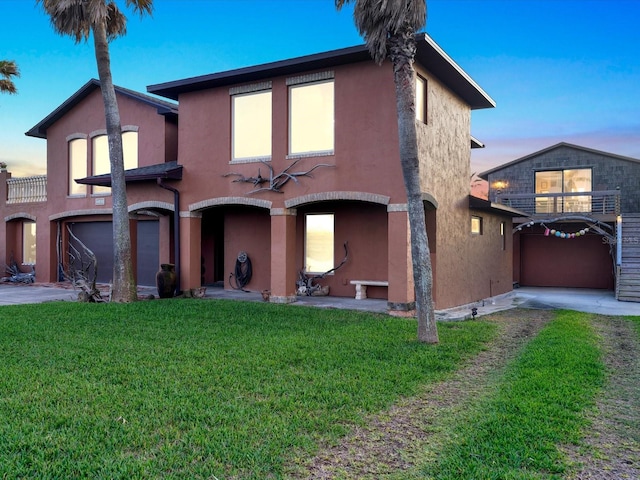 view of front of home with a yard and a garage