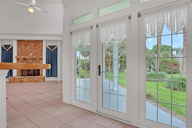 doorway featuring ceiling fan and light tile patterned floors