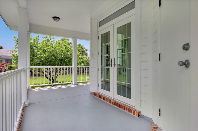 view of patio featuring french doors and a porch