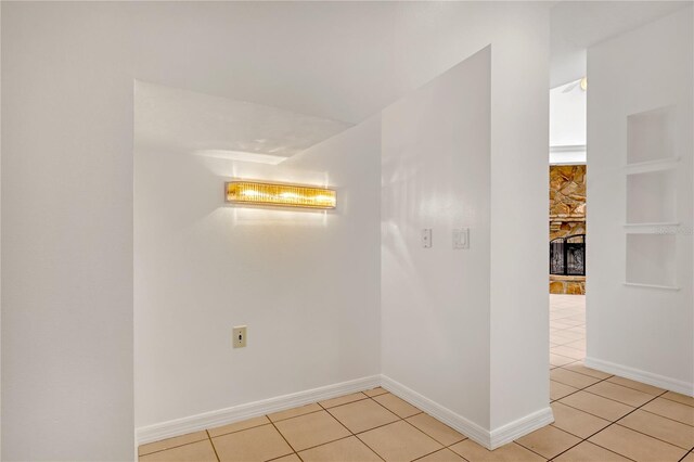 tiled empty room with a fireplace