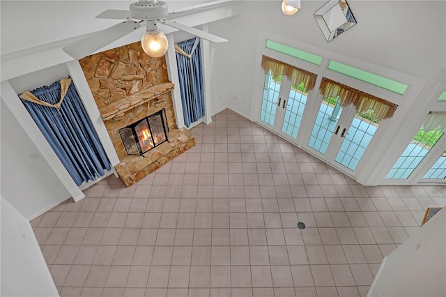 living room featuring ceiling fan and a fireplace