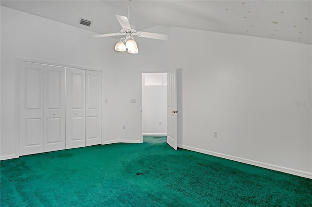 unfurnished bedroom featuring carpet, lofted ceiling, ceiling fan, and a closet