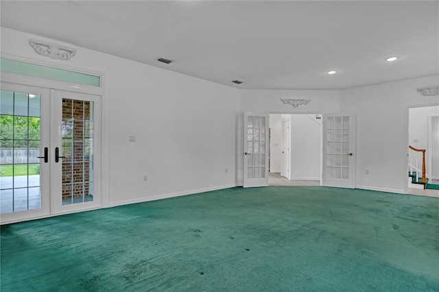 unfurnished living room featuring carpet flooring and french doors