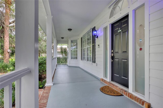 doorway to property featuring covered porch